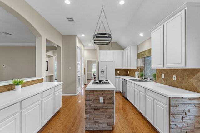 kitchen featuring light countertops, a sink, and white cabinetry