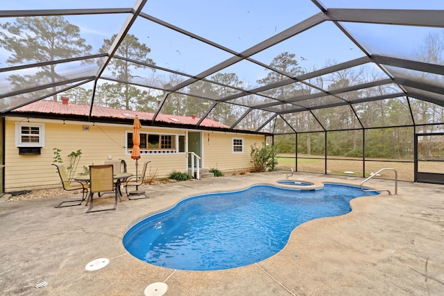 view of pool featuring an in ground hot tub, glass enclosure, and a patio area