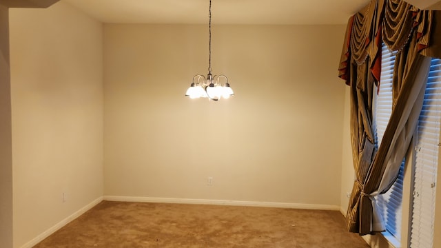 unfurnished dining area featuring a chandelier and carpet flooring