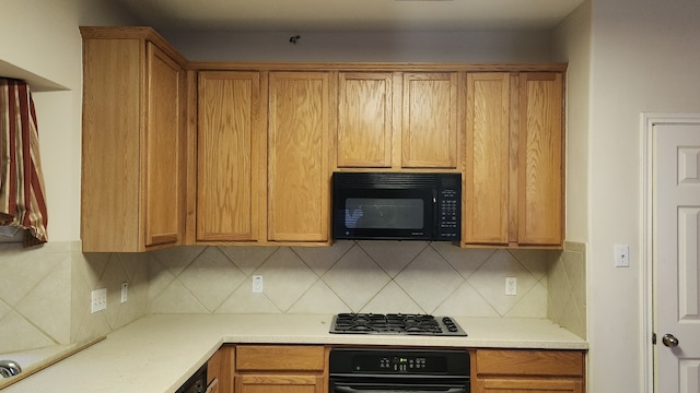 kitchen with backsplash and black appliances