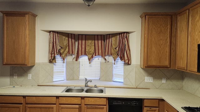 kitchen featuring sink, decorative backsplash, and black appliances