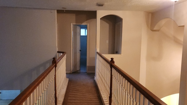 hallway with a textured ceiling