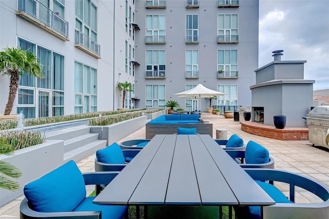 view of community with outdoor dining area and a patio area