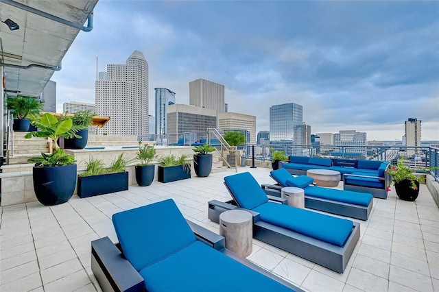 view of patio / terrace featuring a view of city and an outdoor hangout area