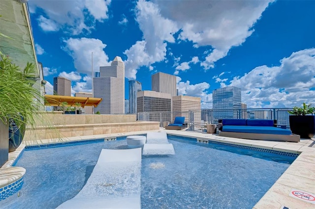 community pool with a view of city and a patio