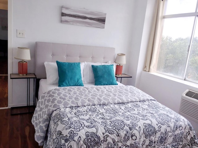 bedroom with dark wood-type flooring