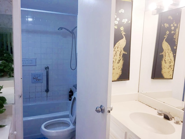 full bathroom featuring vanity, toilet, and tiled shower / bath