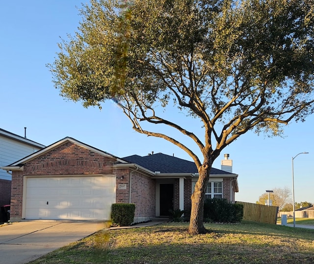 ranch-style house featuring a garage and a front yard