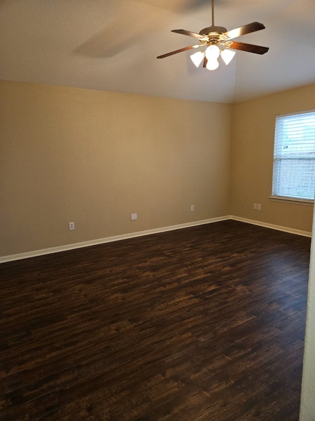 empty room featuring ceiling fan, lofted ceiling, and dark hardwood / wood-style flooring