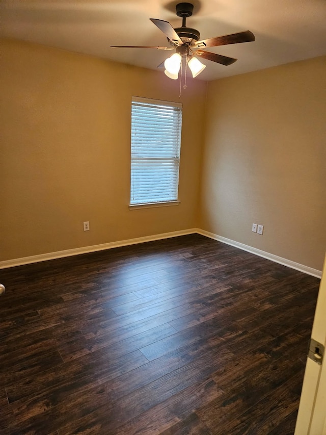 empty room with ceiling fan and dark hardwood / wood-style floors