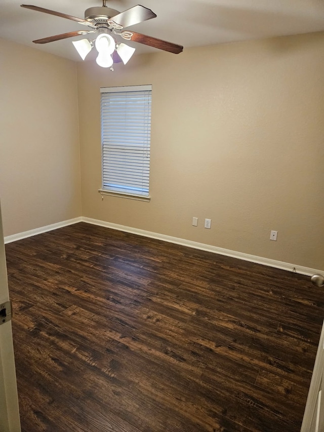 spare room featuring dark hardwood / wood-style floors and ceiling fan