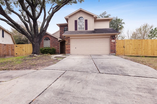 traditional home featuring driveway, an attached garage, fence, and brick siding