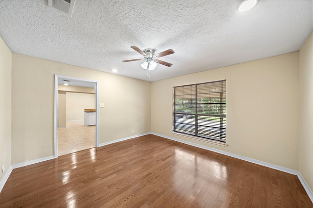 unfurnished bedroom with light wood-type flooring, visible vents, and baseboards