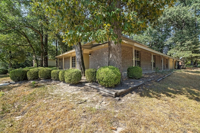 view of side of property with a yard