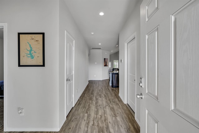 hall with recessed lighting and light wood-style floors