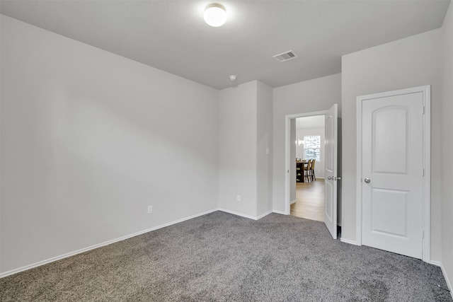 unfurnished bedroom with carpet flooring, visible vents, and baseboards