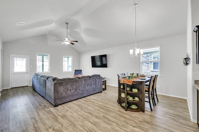 living room with vaulted ceiling, wood finished floors, and baseboards