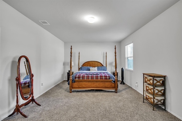 carpeted bedroom with visible vents and baseboards