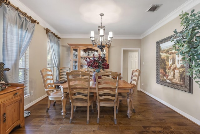 dining area featuring ornamental molding, dark hardwood / wood-style floors, and a chandelier