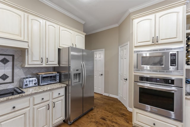 kitchen featuring appliances with stainless steel finishes, backsplash, ornamental molding, light stone counters, and dark wood-type flooring