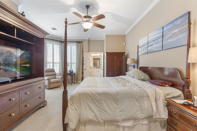 carpeted bedroom featuring ensuite bath, ornamental molding, and ceiling fan