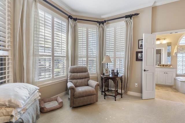 sitting room featuring crown molding and light colored carpet