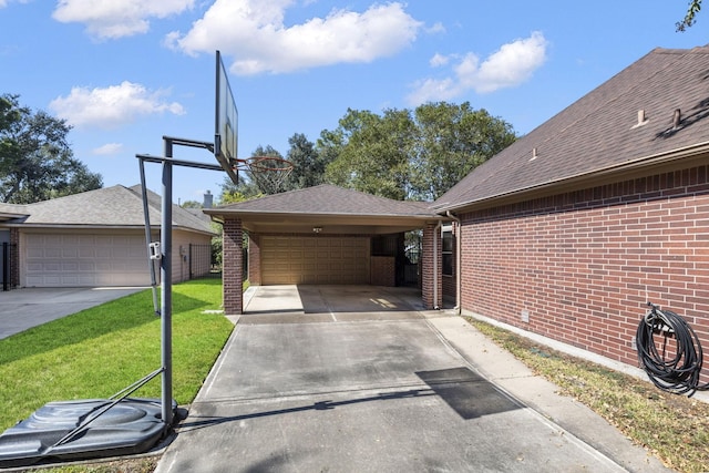 exterior space with a carport, a garage, and a yard