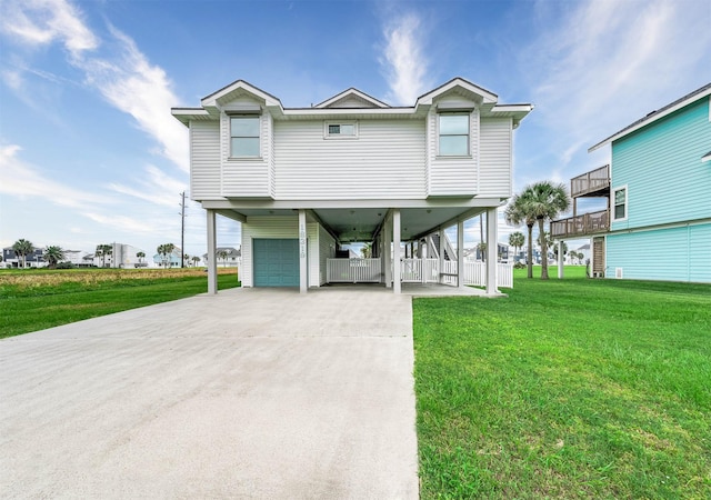 raised beach house with a garage, driveway, a front yard, and a carport
