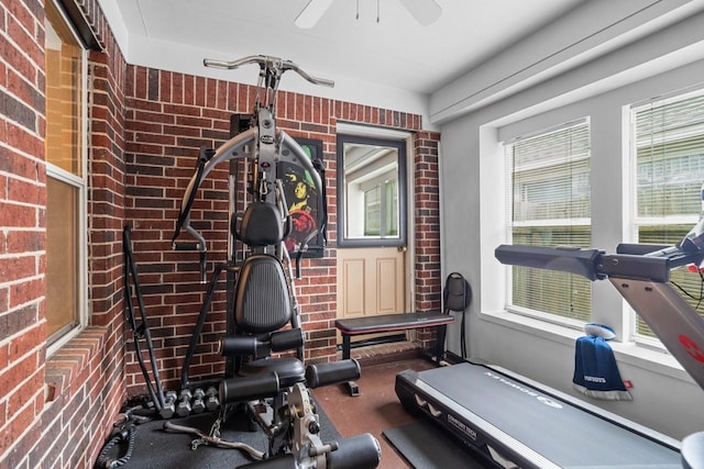 workout area featuring brick wall