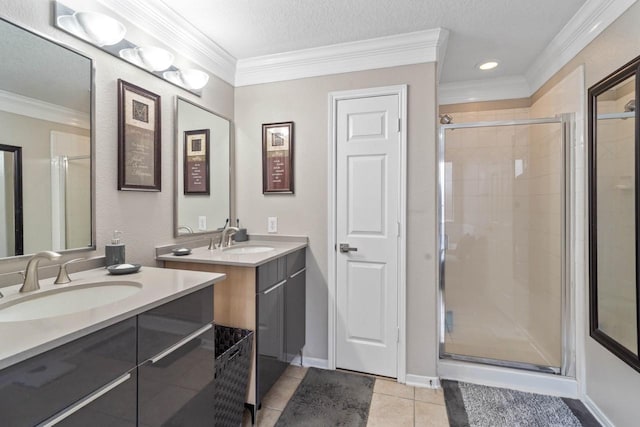 bathroom featuring tile patterned floors, ornamental molding, a textured ceiling, vanity, and walk in shower