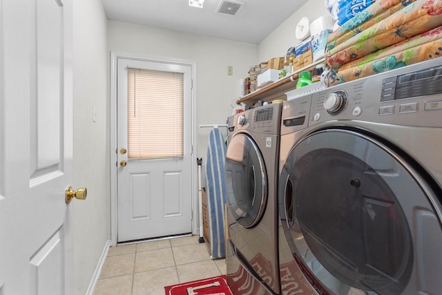 washroom with light tile patterned flooring and washing machine and clothes dryer