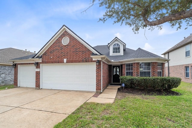 view of front of house with a garage and a front yard