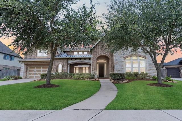 tudor-style house with a garage and a yard