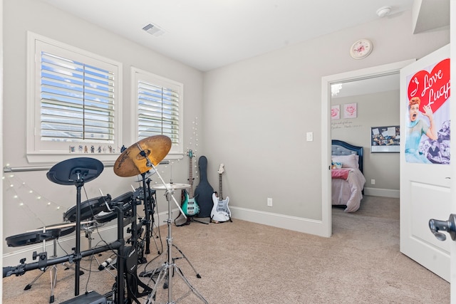 exercise room with light colored carpet