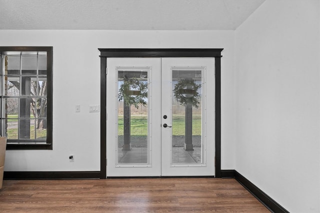 entryway with a healthy amount of sunlight, french doors, a textured ceiling, and dark hardwood / wood-style floors