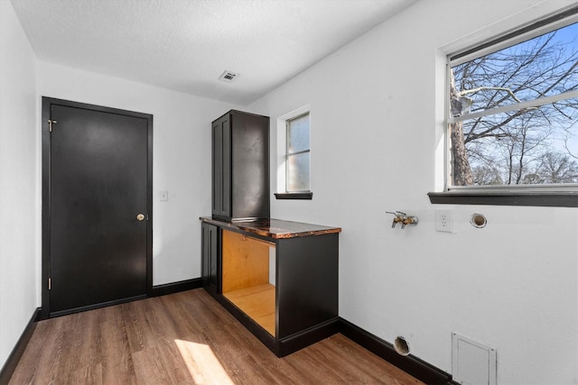 unfurnished bedroom with dark hardwood / wood-style floors and a textured ceiling