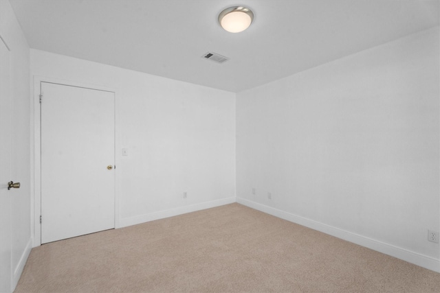 unfurnished room with light colored carpet