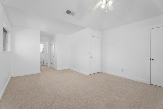 empty room featuring light colored carpet and ceiling fan