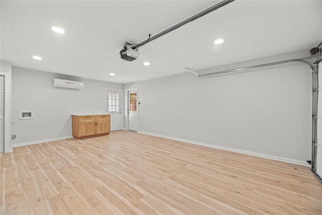 garage with a garage door opener and a wall mounted AC