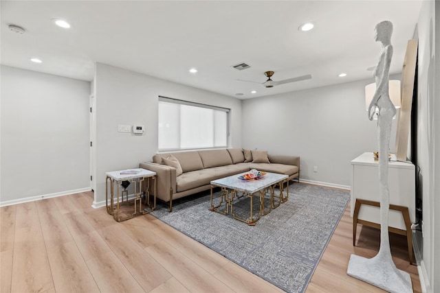 living room featuring ceiling fan and light hardwood / wood-style flooring