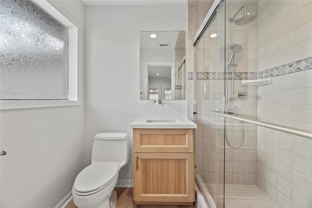 bathroom with vanity, toilet, and walk in shower