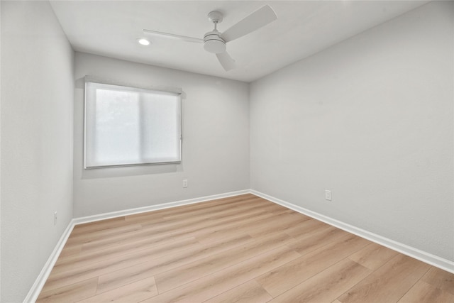 spare room featuring ceiling fan and light hardwood / wood-style floors