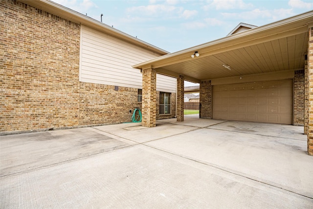 view of home's exterior featuring a garage and a carport