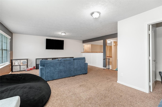 carpeted living room featuring a textured ceiling