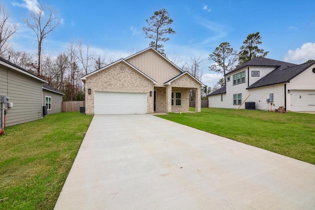 view of front of property with a garage, central AC, and a front yard