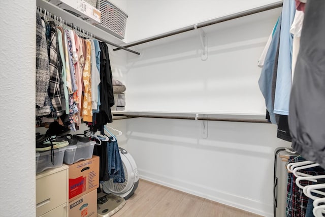 spacious closet with light hardwood / wood-style floors