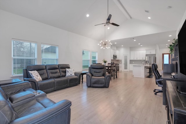 living room featuring beamed ceiling, high vaulted ceiling, ceiling fan with notable chandelier, and light hardwood / wood-style floors