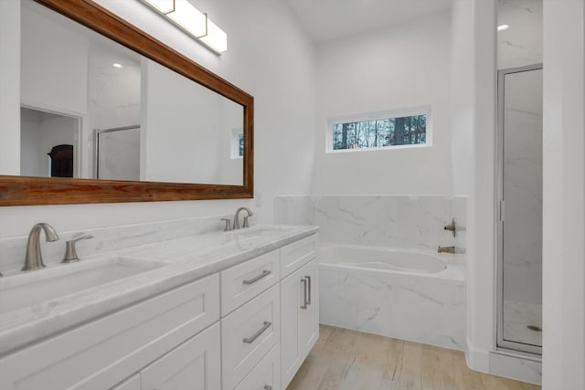 bathroom with vanity, separate shower and tub, and hardwood / wood-style floors