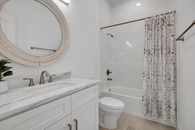 full bathroom featuring toilet, vanity, shower / bathtub combination with curtain, and hardwood / wood-style floors