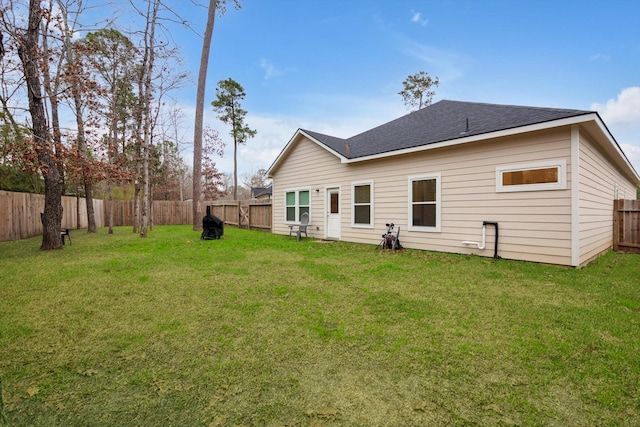 rear view of house featuring a lawn